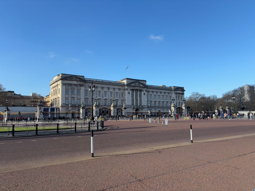 A historic governmental or royal building constructed from beige and light brown stone, featuring ornate architectural details such as decorative columns, intricate carvings, and a triangular pediment